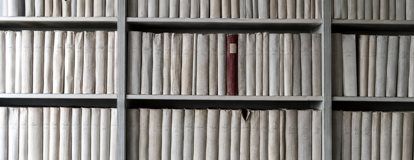 Rows of numbered property record folios in a registry archive