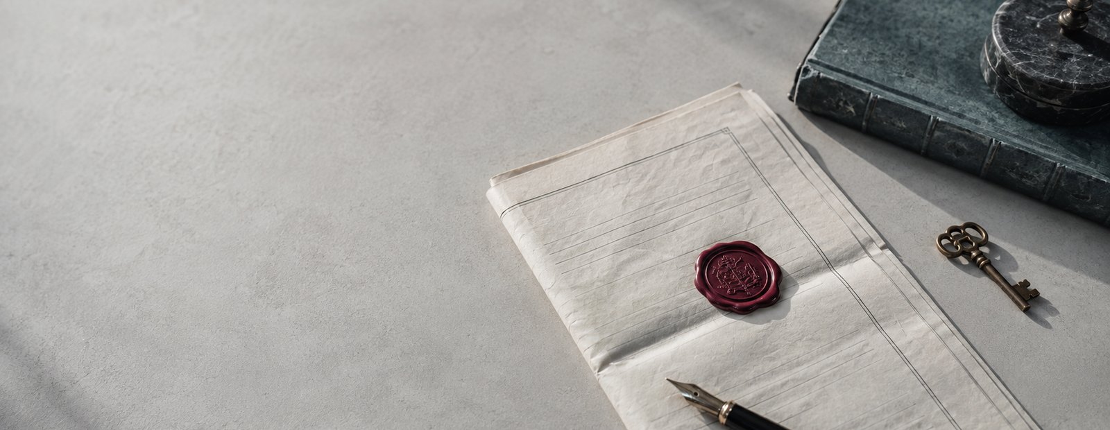 A sealed property deed with a wax seal, fountain pen and key
