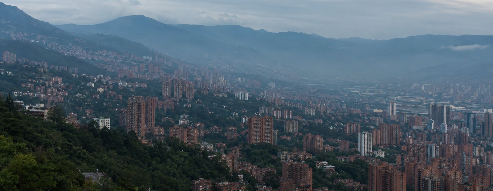 The Aburrá Valley and Medellín's brick towers seen from a hillside at dusk